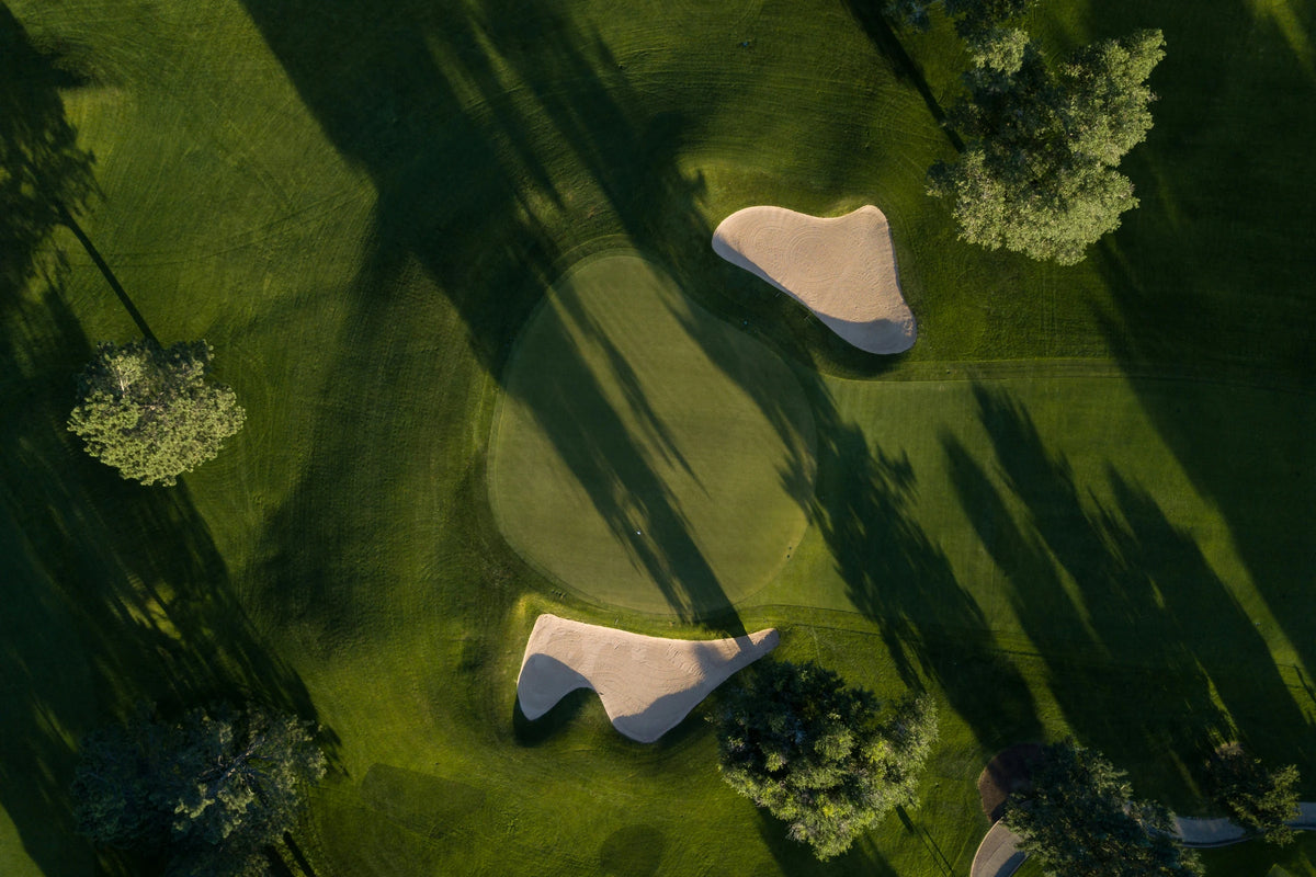 Aerial golf course with green fairways and sand bunkers